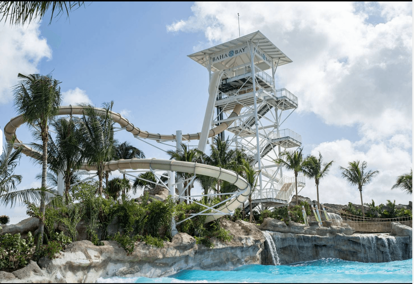 Baha Bay Waterpark slide tower, palms and turquoise pool