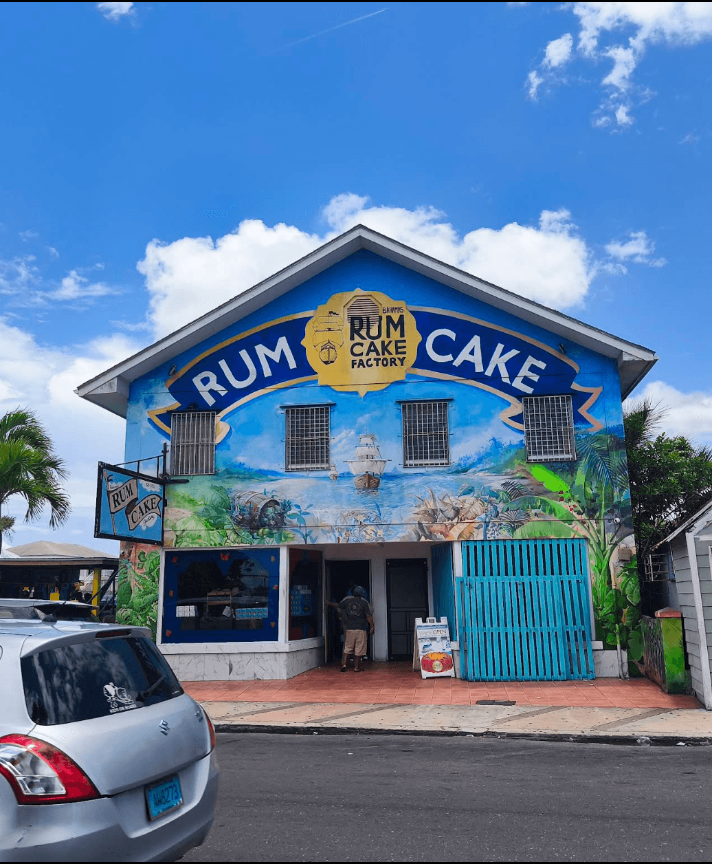 Blue mural-covered facade and entrance of the Bahamas Rum Cake Factory in Nassau