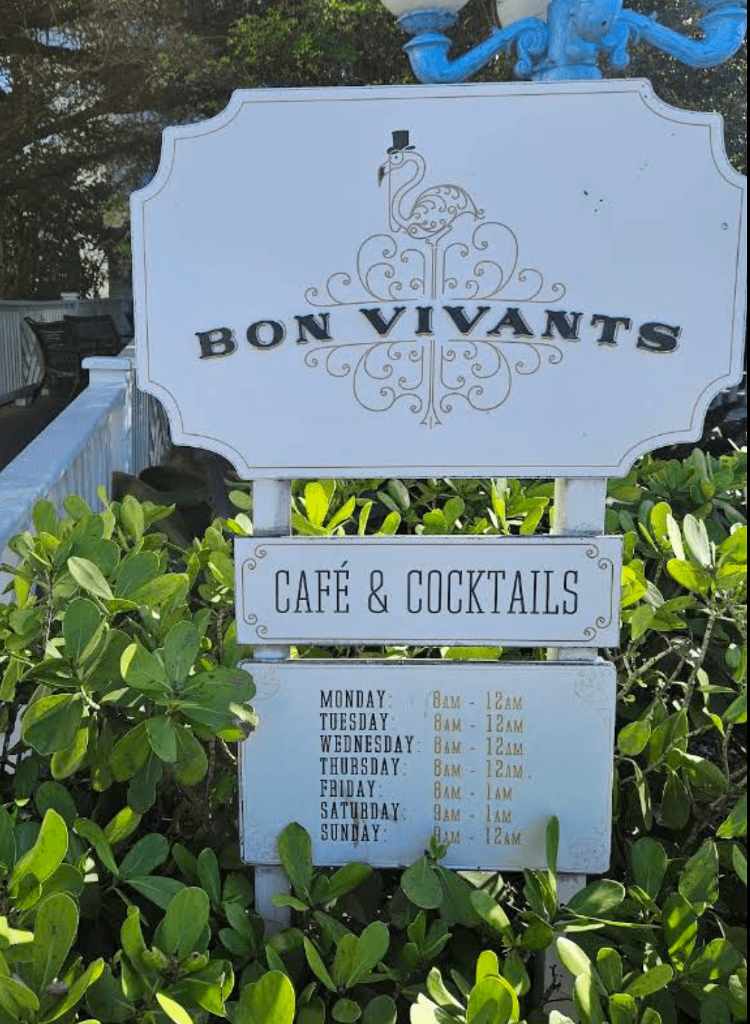 Bon Vivants café and cocktails sign among tropical plants in Sandyport, Nassau