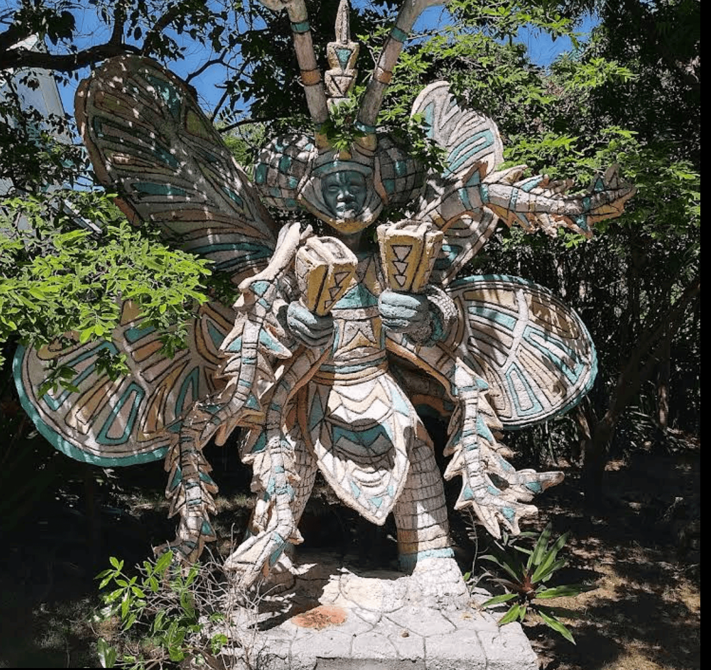 Decorative outdoor sculpture surrounded by trees at Doongalik Studios Art Gallery