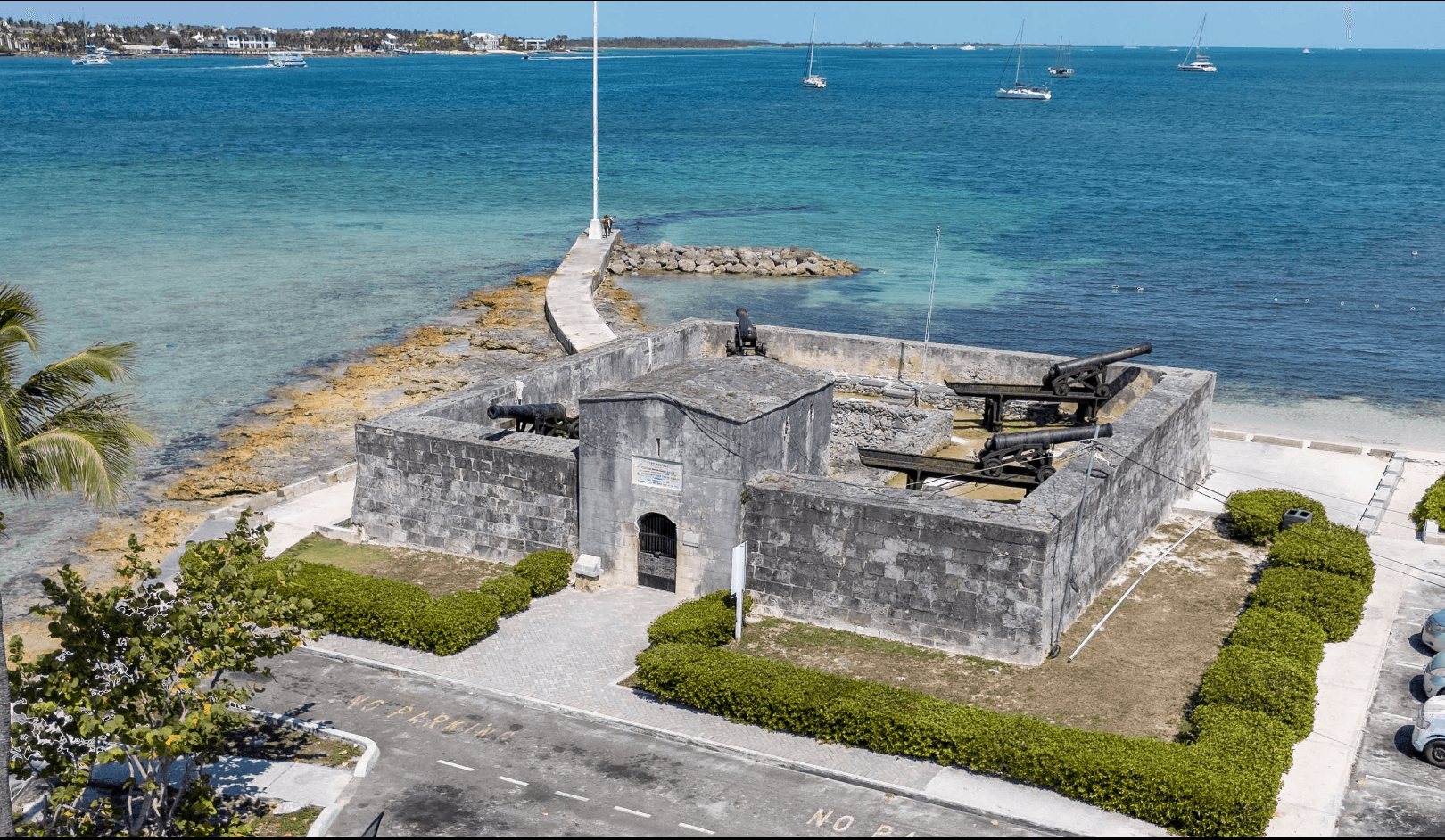 Fort Montagu’s stone walls and cannons beside turquoise water in Montagu Bay