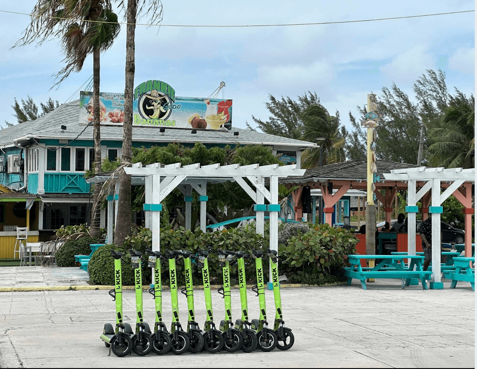 Frankie Gone Bananas restaurant at Arawak Cay, with turquoise seating and scooters outside