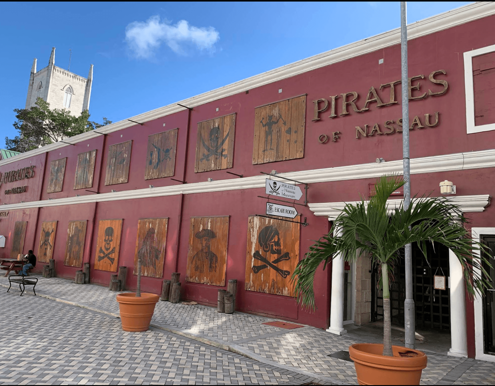 Red Pirates of Nassau Museum facade with wooden pirate emblems and its entrance