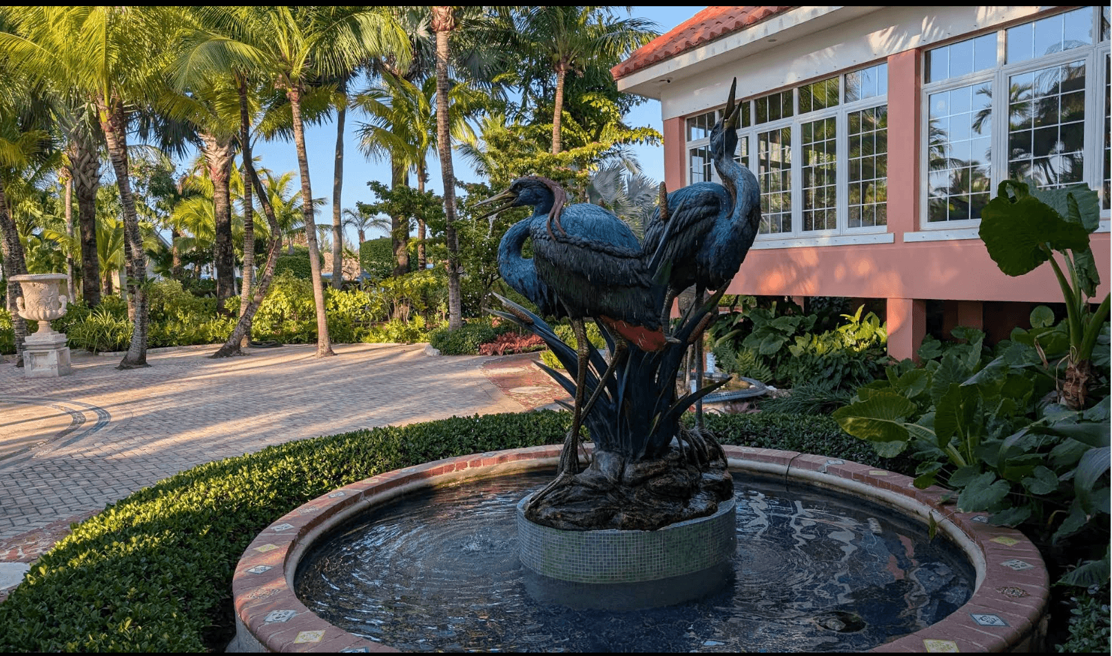 Bird sculpture fountain and palm gardens outside Sapodilla Estate in Nassau